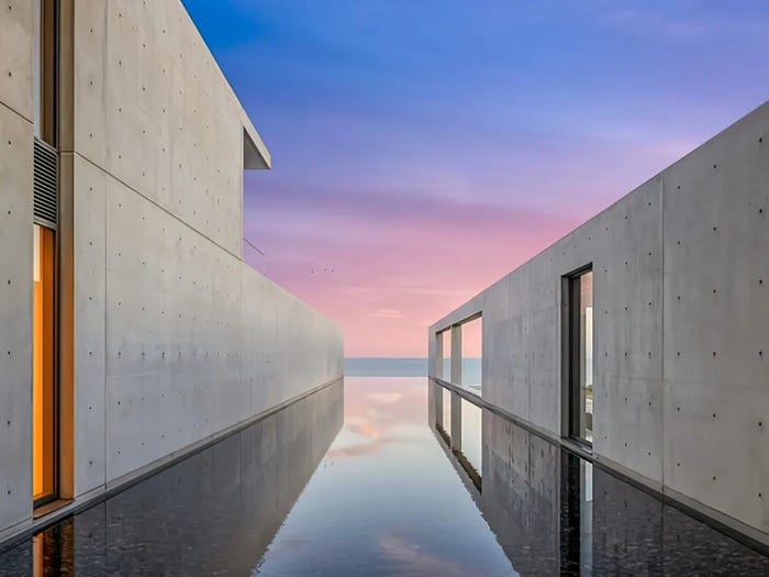 The concrete compound features an infinity pool just steps from the Pacific ocean.