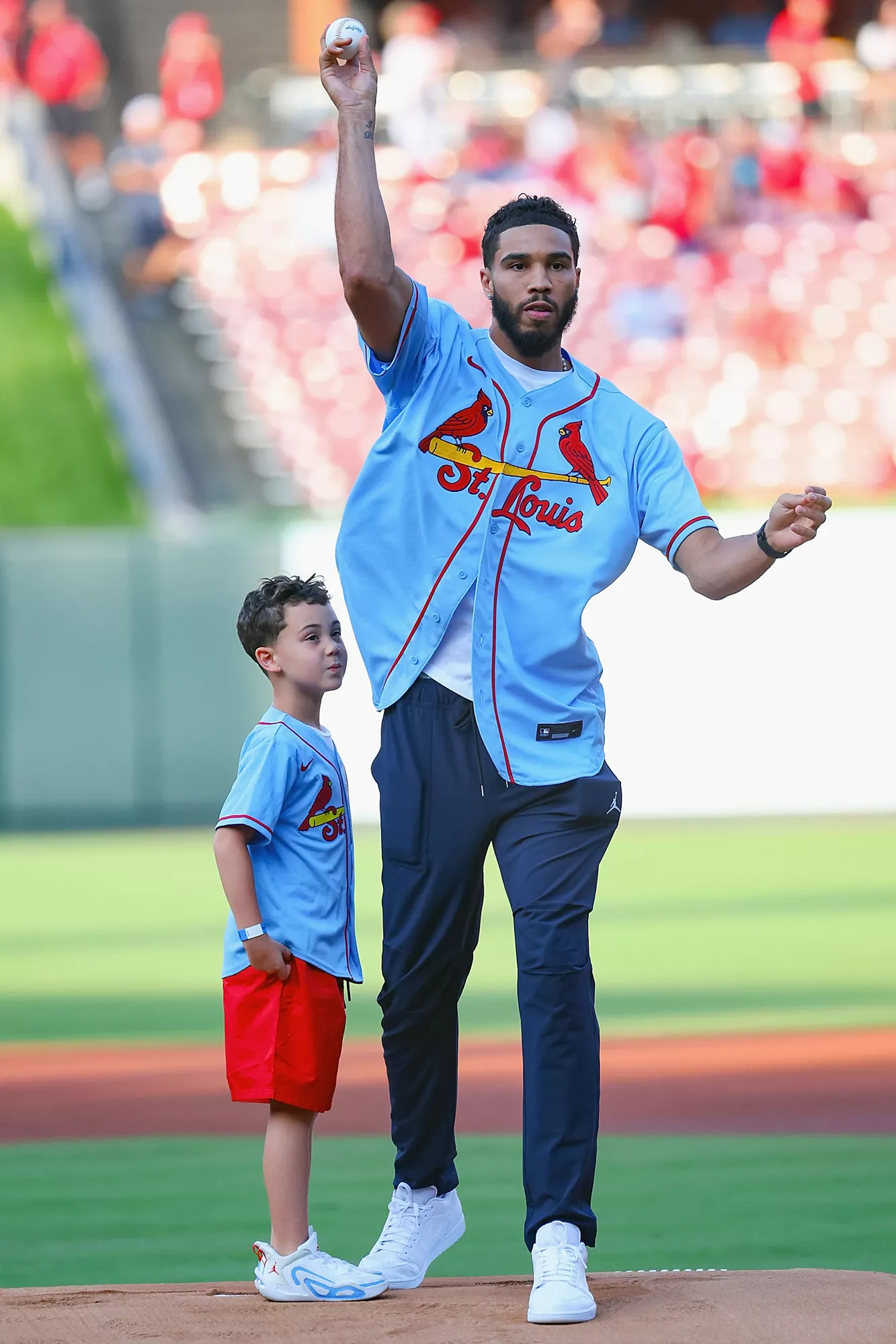 St. Louis native Jayson Tatum throws out the first pitch with his son Jayson Tatum Jr. prior to a game between the St. Louis Cardinals and the Minnesota Twins at Busch Stadium on August 1, 2023 in St Louis, Missouri. 