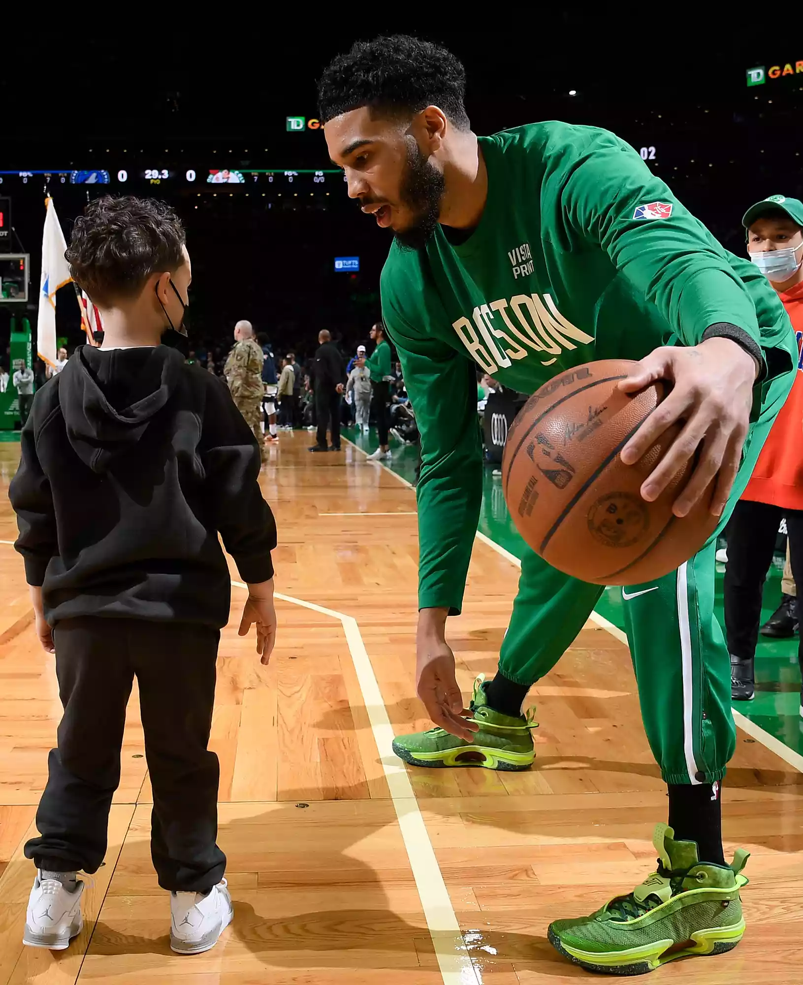 Jayson Tatum #0 of the Boston Celtics warms up with his son, Deuce Tatum on March 27, 2022 at the TD Garden in Boston, Massachusetts